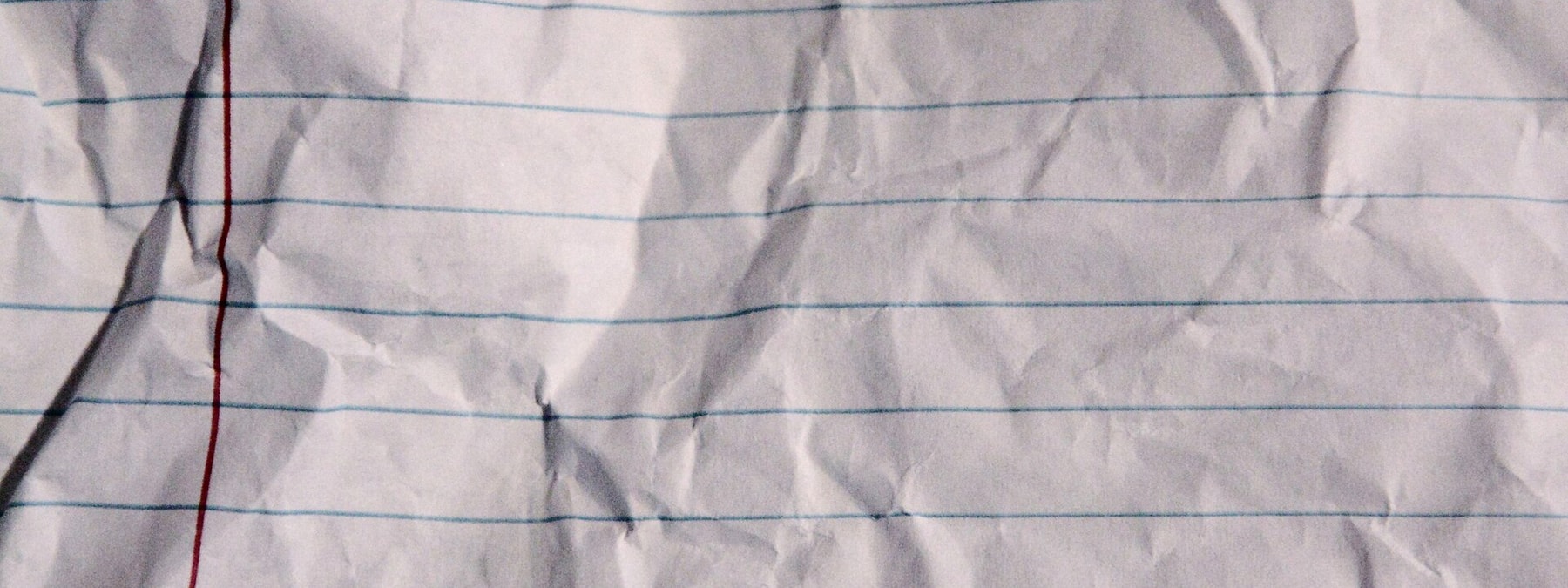 Ruled notebook pages on a linen desk